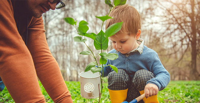 child gardening with adult