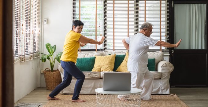 Asian old senior workout exercise and doing tai chi at home