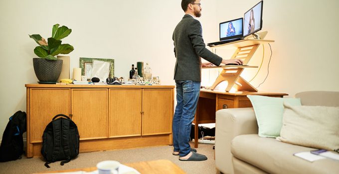 Man using a standing desk to work