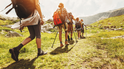 Five hikers walking up a hill