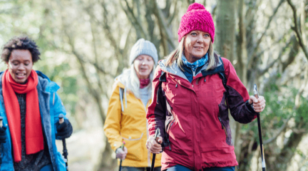 Three women walking through a forest